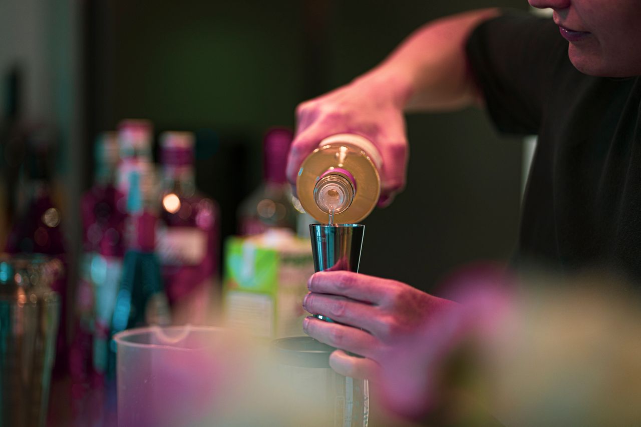 Bartender pouring a cocktail at the bar